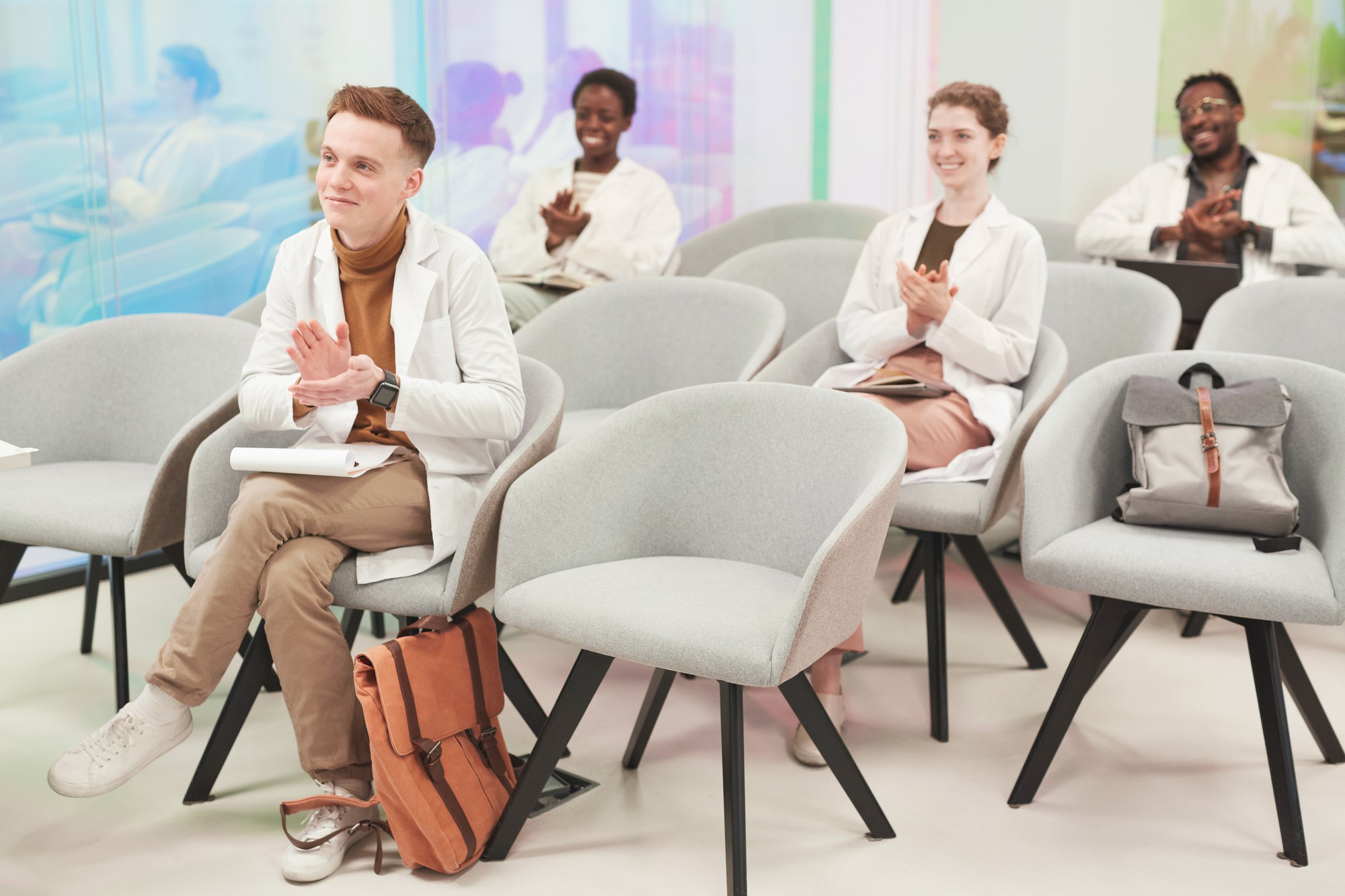 full-length-portrait-multi-ethnic-group-people-applauding-while-sitting-audience-listening-lecture-medicine-college-coworking-center-copy-space