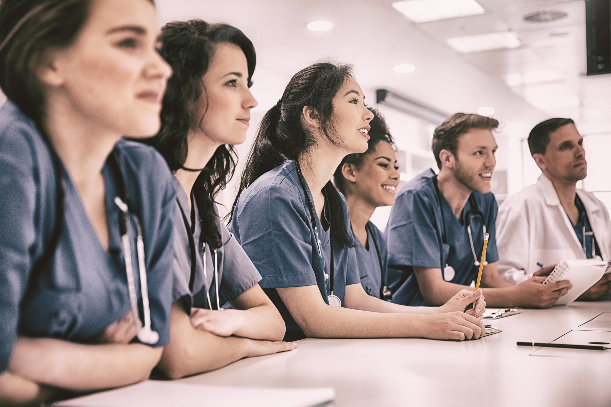 medical-students-listening-sitting-desk